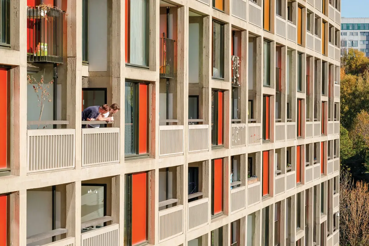 Residents looking out from the colourful balconies of a landmark development